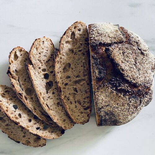 Sourdough Bread, half cut to expose crumb and crust thickness